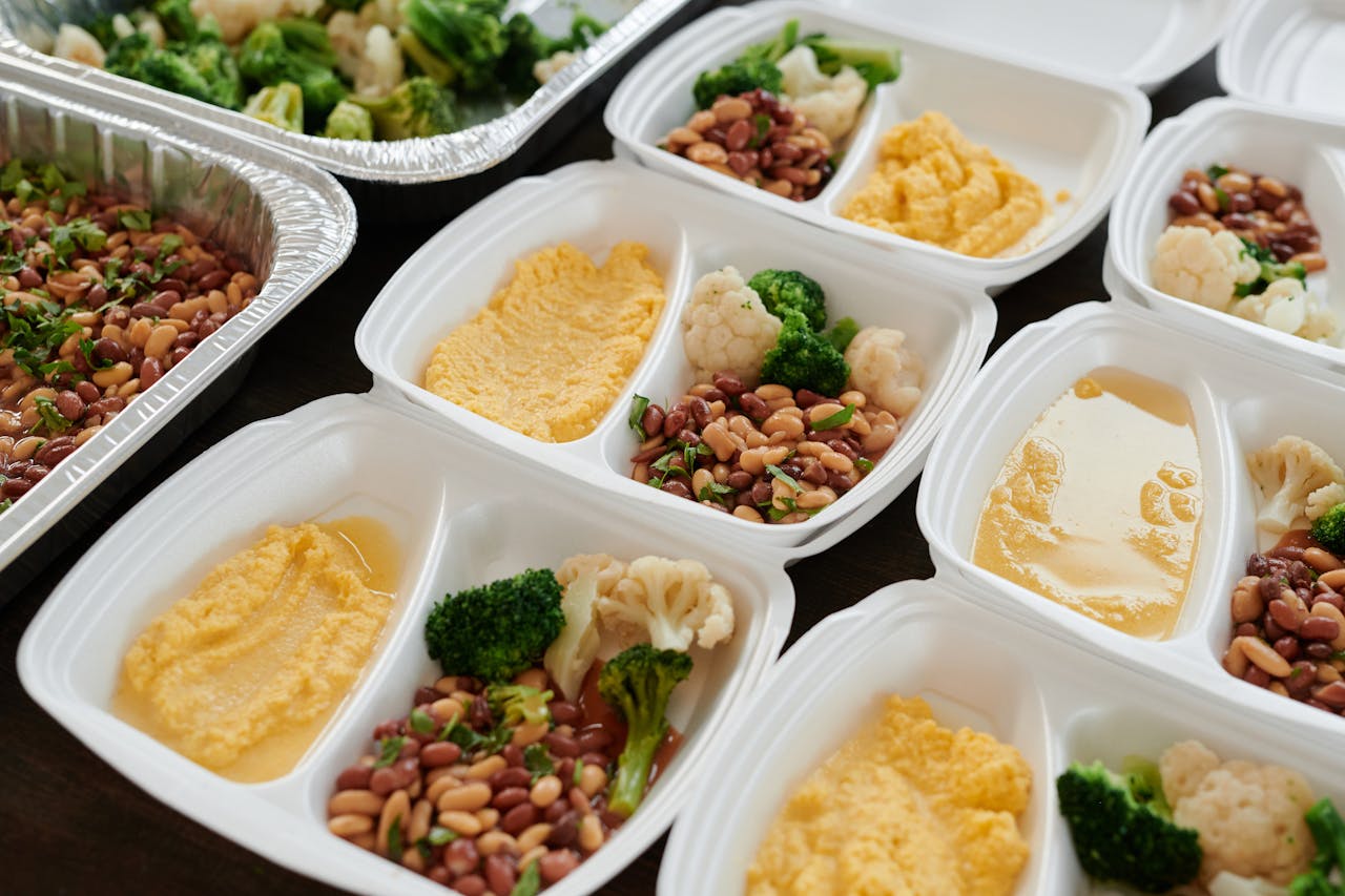 The Art of Drawing Readers In: Your attractive post title goes here Assorted meal prep containers with beans, broccoli, and mashed potatoes, perfect for healthy eating.